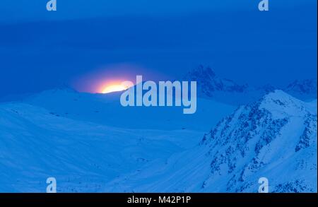 Moony sunset over mountains of Bormio and Livigno in Lombardy Alps Stock Photo