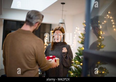 Man giving woman Christmas gift Stock Photo