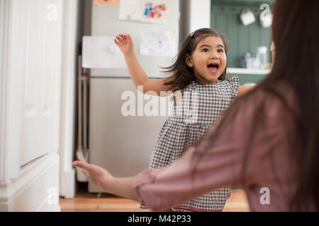 Girl running into mother’s arms Stock Photo