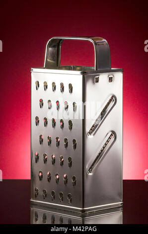 Metal stainless steel grater isolated on gradient background Stock Photo