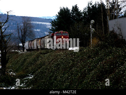 Freight train approaching railbridge over Fraser River, British Columbia Stock Photo