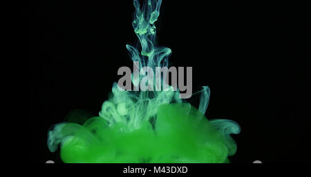 Green Ink Colors in Water Creating Liquid Art Shapes Stock Photo