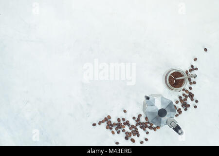 Geyser coffee maker with beans and ground coffee in a glass jar. High key drink photography from above. Stock Photo