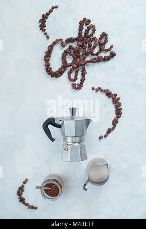 Minimalist flatlay with food typography. Word Coffee made with coffee beans. Moka pot alternative brewing. Stock Photo