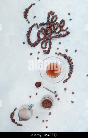 Food lettering in high key drink photography from above. Word Coffee made with coffee beans. Moka pot alternative brewing. Stock Photo
