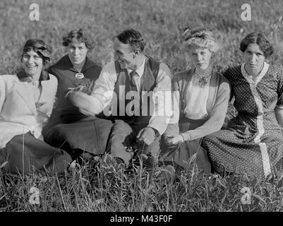 One happy and lucky guy is surrounded by four young women, ca. 1920. Stock Photo