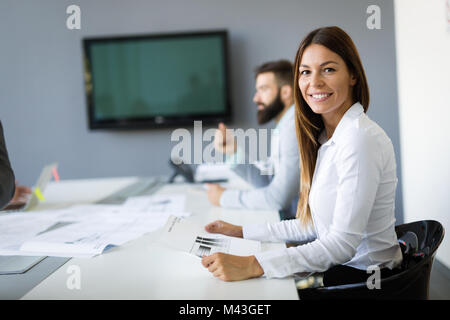 Team of architects working on construction plans Stock Photo