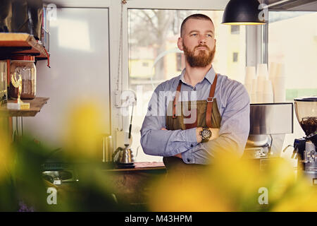 Redheads seller in a small coffee house. Stock Photo