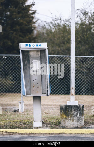 Abandoned payphone box. Phone is missing. Stock Photo