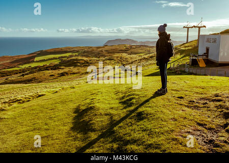 A woman takes in the views form the cable car station on top of the Great Orme in Llandudno, Wales, UK. Picture Credit: Brian Hickey/Alamy Stock Photo
