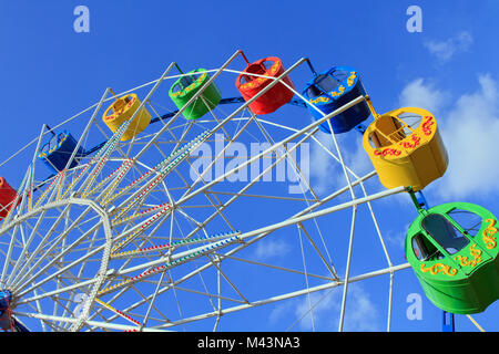 Underside view of a ferris wheel over blue sky Stock Photo