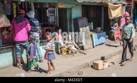 People Shopping and Sitting in Dirty Street, Madagascar Stock Photo