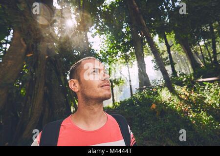 Adventure vacations in nature. Young man (traveler) looking at the nature around him. Stock Photo