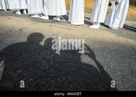 Easter traditional procession in brotherhood with tourist shadows Stock Photo