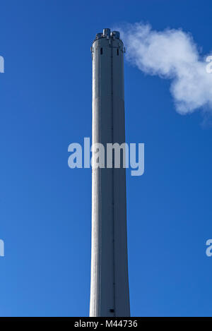 Smoking chimney from heating plant in dark inversion weather in winter ...