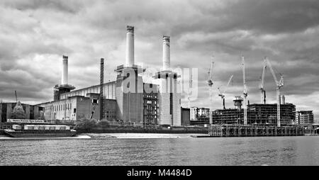 The gutted shell of Battersea Power Station, with only three chimneys, seen from the River Thames during redevelopment, April 2015, London England UK Stock Photo