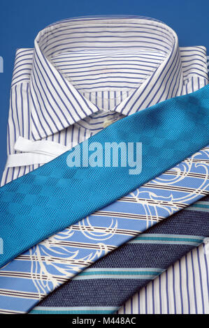 ties of different colors lie on a shirt Stock Photo