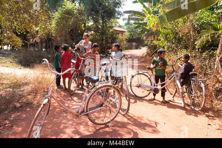 PHNOM PENH, CAMBODIA - JANUARY 05 2015: Cambodian children are students going to classes at the school on bicycles Stock Photo