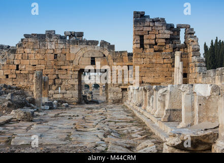 Ruins of Appollo temple with fortress at back in ancient Corinth, Peloponnese, Greece Stock Photo