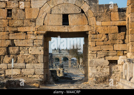 Ruins of Appollo temple with fortress at back in ancient Corinth, Peloponnese, Greece Stock Photo