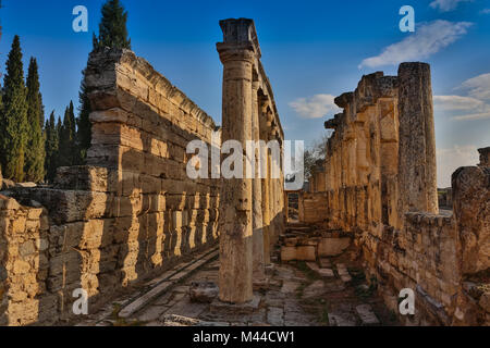 Ruins of Appollo temple with fortress at back in ancient Corinth, Peloponnese, Greece Stock Photo