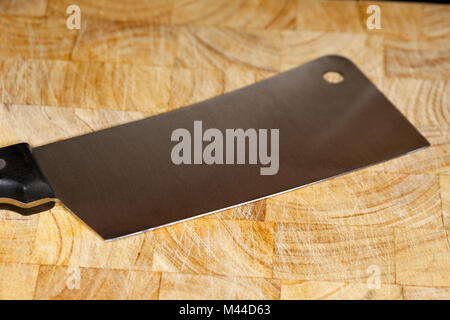 chinese cleaver knife sitting on a wooden butchers block Stock Photo