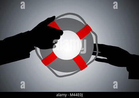 Silhouette Of A Two Person's Hand Passing Lifebuoy Against Gray Background Stock Photo