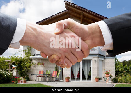 Cropped closeup of realtor shaking hands with client after selling house Stock Photo