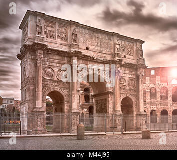 Rome, Arch of Constantine on a winter and cloudy day, Colosseum in the background Stock Photo