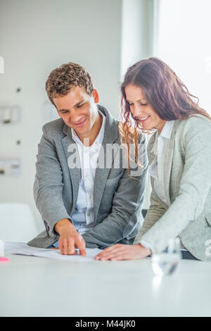 Happy young design professionals working together in office Stock Photo