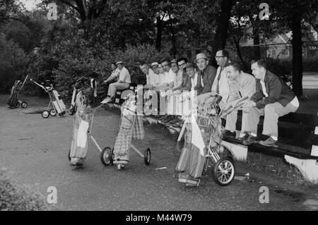 A group of men wait on a public golf course for their tee times in suburban Chicago, ca. 1965. Stock Photo