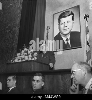 Chicago Mayor Richard J. Daley speaks at a memorial service for President Kennedy in Chicago in 1963.  Seated in front are Daly sons John,left, and future mayor, Richard M. Daley. Stock Photo