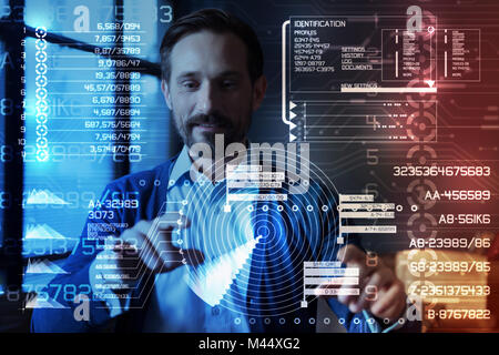 Cheerful programmer looking impressed while working with a new program Stock Photo