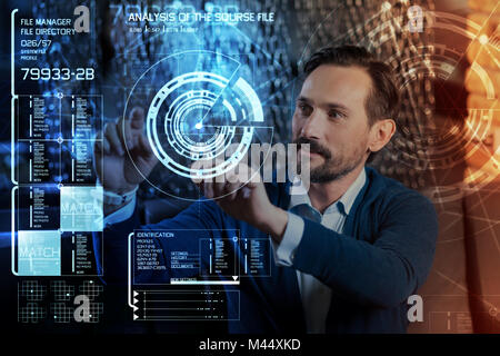 Enthusiastic software specialist looking impressed while working Stock Photo