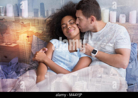 Positive handsome man kissing his girlfriend Stock Photo