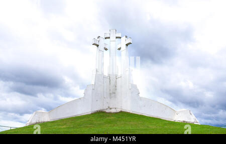 Three Crosses in Vilnius, Lithuania on a hill against stormy and dramatic clouds. Stock Photo