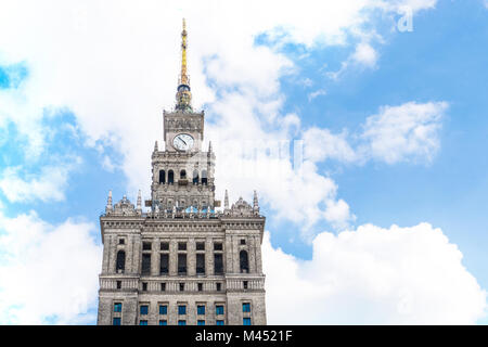 The highest top of the Palace of Culture and Science in Warsaw Poland against partly cloudy sky on a summer day. Stock Photo