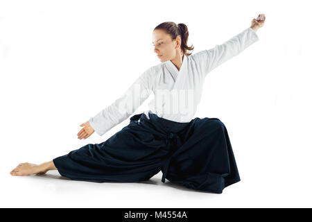 Aikido master practices defense posture. Healthy lifestyle and sports concept. Woman in white kimono on white background. Stock Photo