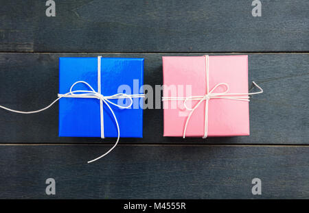 Pink and blue gift boxes on blue wooden background, copy space, top view Stock Photo