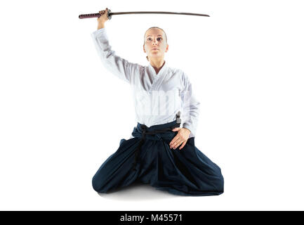 Aikido master practices defense posture. Healthy lifestyle and sports concept. Woman in white kimono on white background. Stock Photo