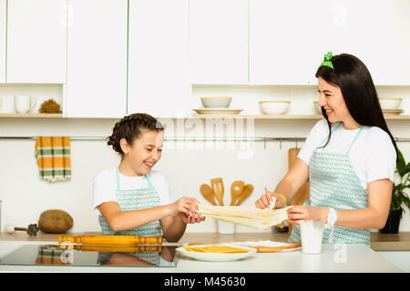 happy mother and daughter cooking at the kitchen Stock Photo
