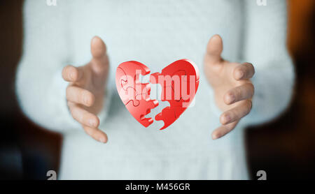 Broken heart on hand, concept of love Stock Photo