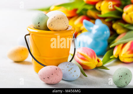 Easter composition with quail eggs and tulips Stock Photo