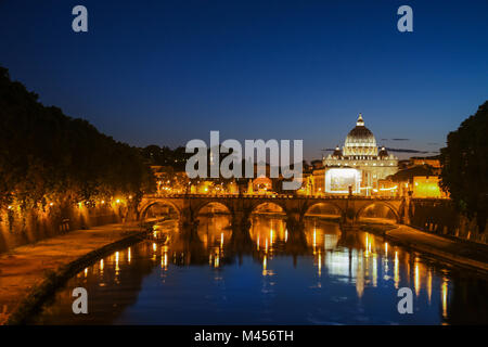 Night view of St. Peter's Basilica. Ponte Sant Angelo and Tiber River in Rome - Italy. Dramatic sunset with sbeautiful water reflection. Italy postcard Stock Photo