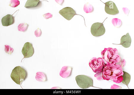 Styled stock photo. Feminine wedding desktop composition with pink roses petals and flowers, dry green eucalyptus leaves and white background. Floral  Stock Photo