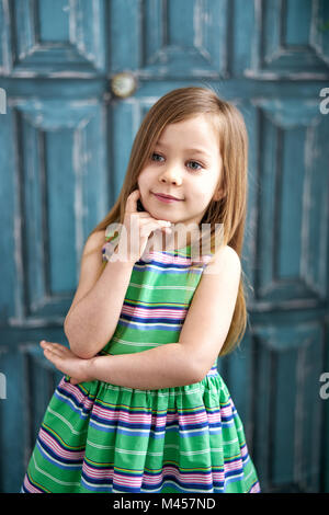 Little girl in green dress and long hair Stock Photo
