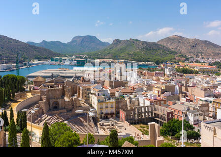 The Roman Theatre at Cartagena with the port beyond viewed from Torres Park, Spain. Stock Photo