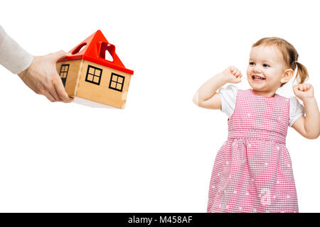 Happy toddler girl receiving a toy house Stock Photo