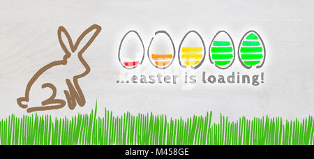 Easter is loading with colorful eggs and Easter Bunny on light wood. Stock Photo