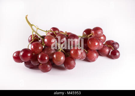 red grapes with stalks isolated on white background. fresh red grapes Stock Photo
